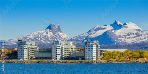 The Modern Buildings in Norwegian City Bodo, Mountains Wiht Snow in Background,  Norway. photo