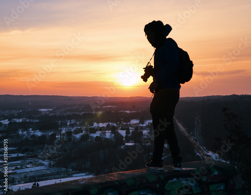 Fototapeta Naklejka Na Ścianę i Meble -  Person standing during sunset or sunrise