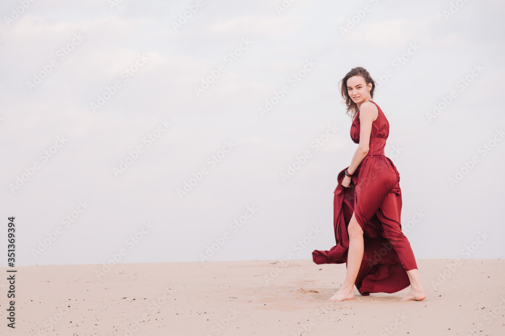 Girl in red dress at sunset in the desert Girl in red dress at sunset in the desert