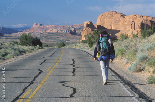 A man walking on the highway, Arches National Park, UT © spiritofamerica