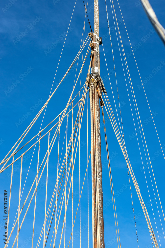 Pulleys, ropes, and mast of an old sailing yacht Pulleys, ropes, and mast of an old sailing yacht