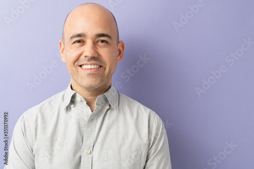Photos Happy bald guy smiling in a studio