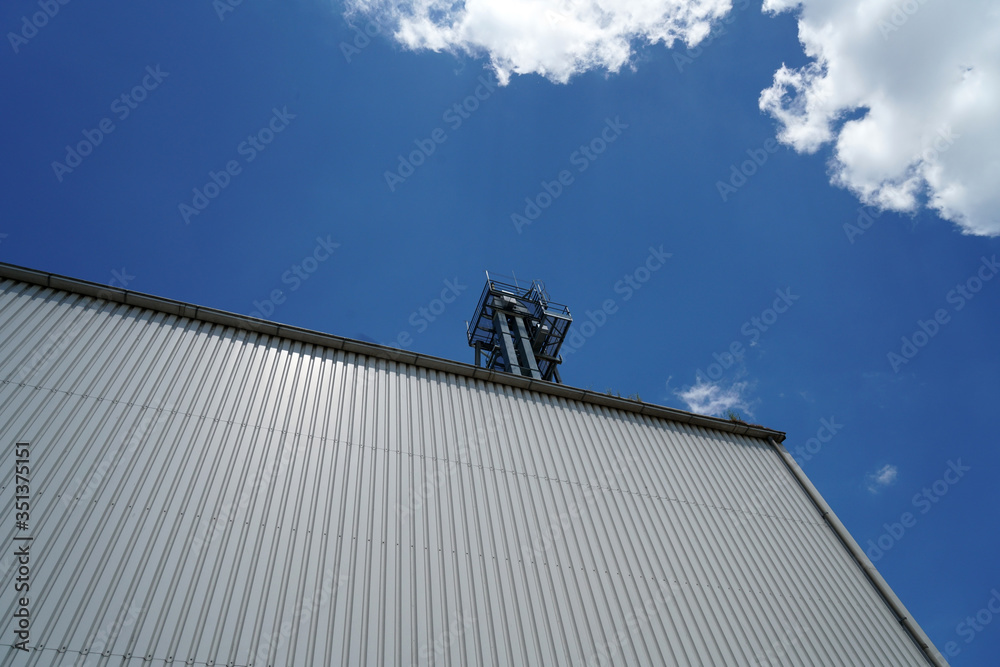 Factory barrels in industrial areas with aluminum as outer cladding photographed in summer
