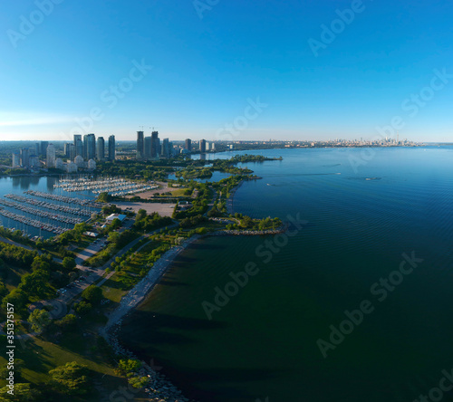 Amazing North American panorama at Humber Bay Shores Park city and green space, skyline cityscape, yacht and boats in azure lake Ontario. Skyscrapers and blue marina, sunset at summer, Ontario, Canada