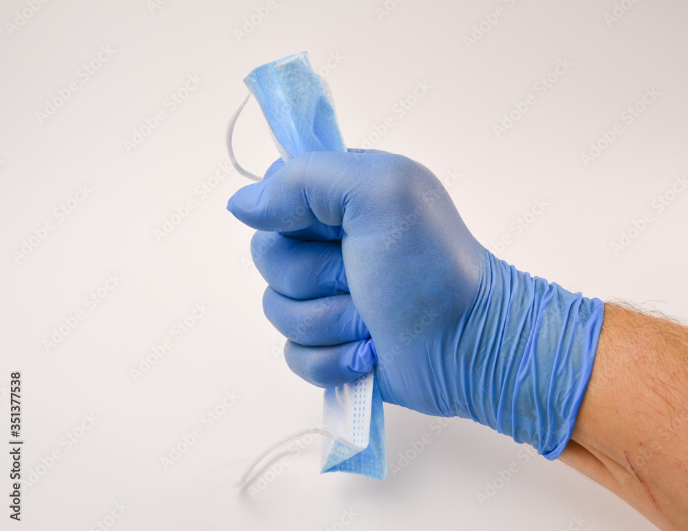 hand in glove holding a syringe hand in glove holding a syringe
