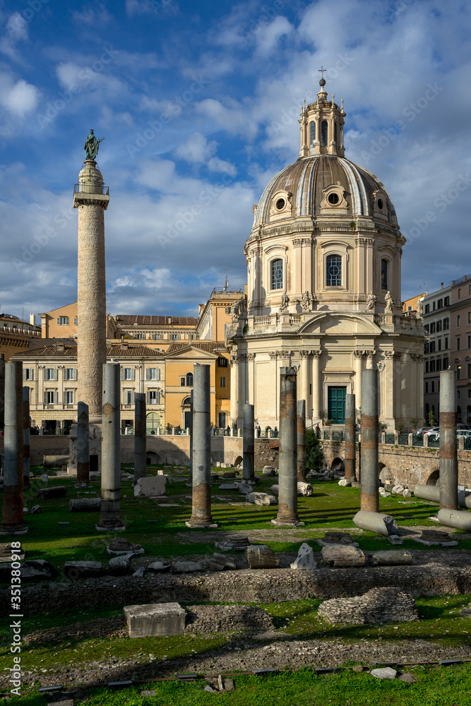 Rome, Italy: in close up archaeological ruins of the square of trajan forum, on the left  of the image the trajan column,  on the right the church of  Santissimo nome di Maria.
