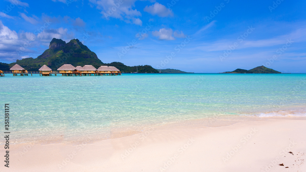 Bora Bora lagoon with mountains and overwater huts