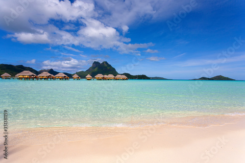 Bora Bora lagoon with mountains and overwater huts