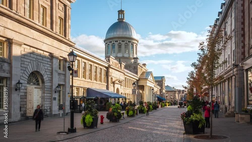 Zoom out timelapse view of historical landmark Bonsecours Market in the heart of Old Montreal on a sunny day in Montreal, Quebec, Canada. photo