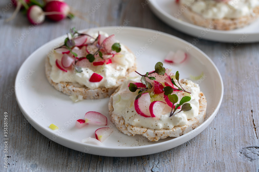 Rice crackers with cottage cheese, radish and micro herbs