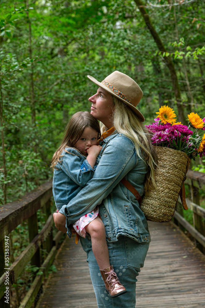 Mother Holding Daughter Lovingly in Woods