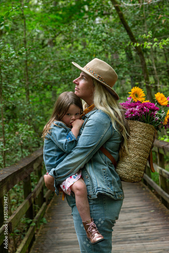 Mother Holding Daughter Lovingly in Woods © Bobby