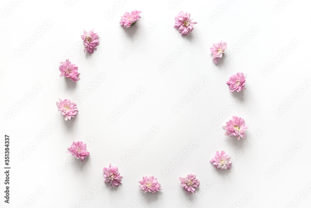 Round frame with pink flowers bud isolated on white background. Flat lay, top view
