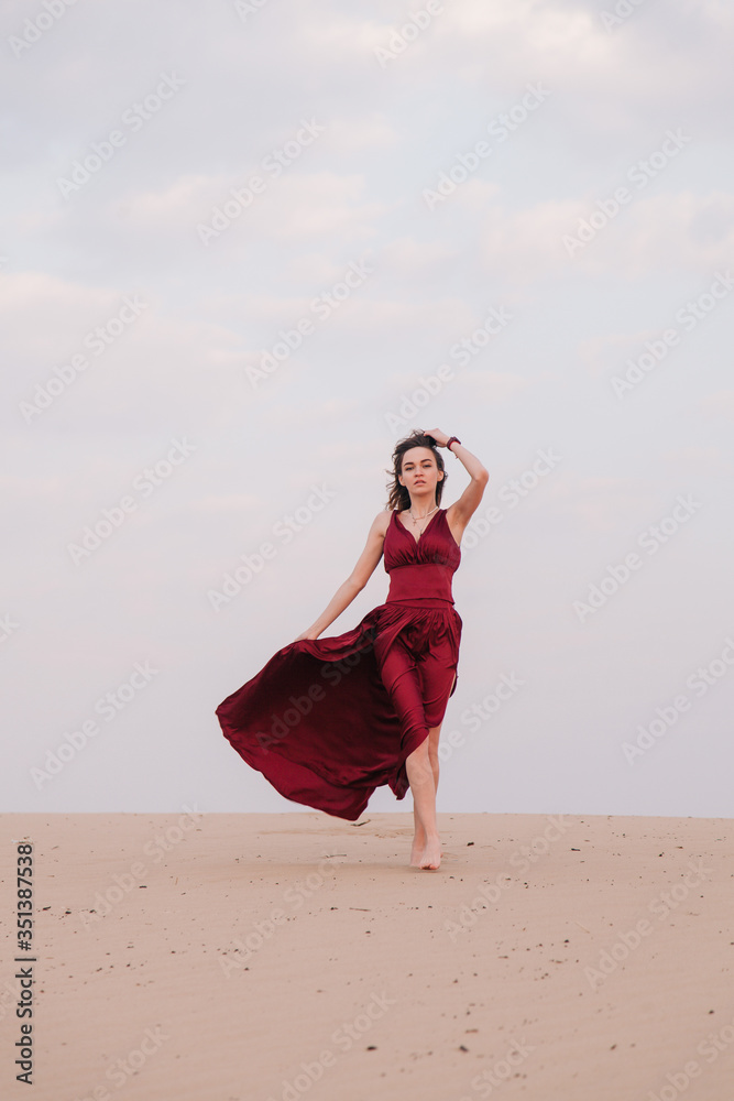 Girl in red dress at sunset in the desert Girl in red dress at sunset in the desert