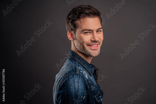 Advertisement concept, side view half face profile with copy space of perfect smiling man standing over gray background