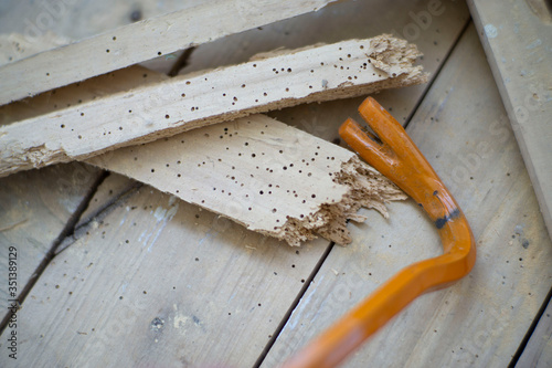 Crowbar on demolished wood eaten by woodworm