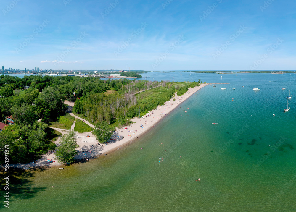 Toronto Central Islands and Ward's Island Park beach, Ontario, Canada, aerial view from top at sunny greenery and sandy coast with boats, people swimming at summer. Popular tourist location.