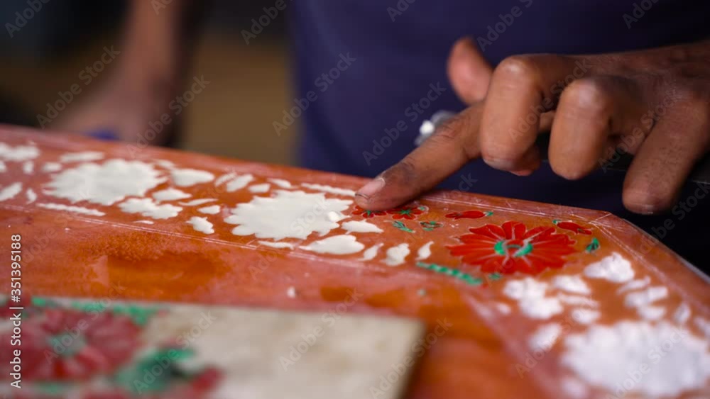Agra, India - Mar 2020: Traditional stone crafts with inlay work known as Parchin kari. Workers creating intricate stone and marble pieces with precious gemstones. Traditional crafts in Agra, India.