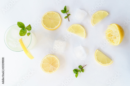 Lemonade lemons, mint and ice on white background natural light