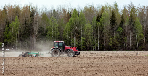 A man on a tractor prepares land for sowing