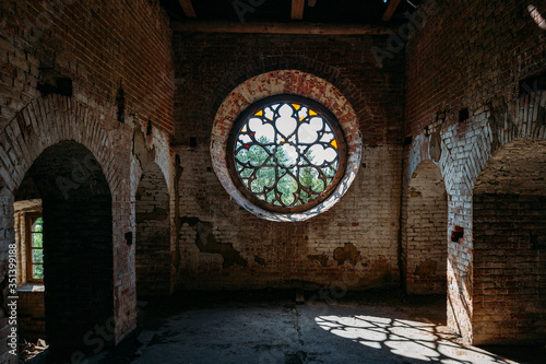 Round stained glass window in old abandoned castle