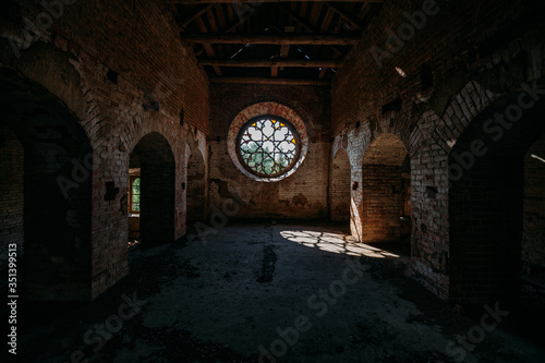 Round stained glass window in old abandoned castle