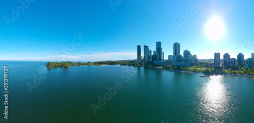 Artistic creative view of Humber Bay Shores Park city view and green space with skyline cityscape, azure lake Ontario. Skyscrapers over The Queensway on sunset at summer, Etobicoke, Ontario, Canada © desertsands