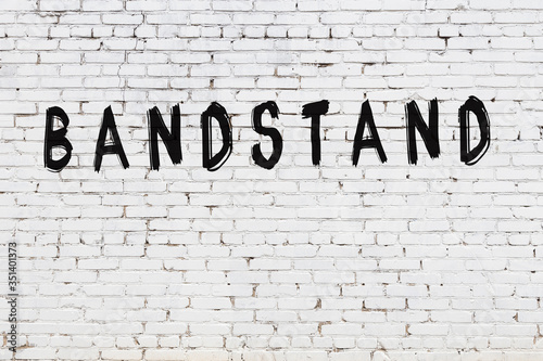 Word bandstand painted on white brick wall