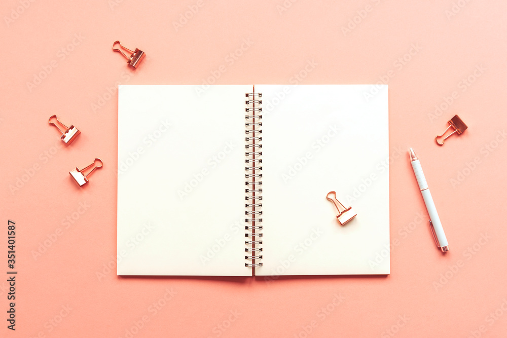 Blank spiral notepad mockup on a coral pink pastel background. Business or education concept. Top view, flat lay Blank spiral notepad mockup on a coral pink pastel background. Business or education concept. Top view, flat lay