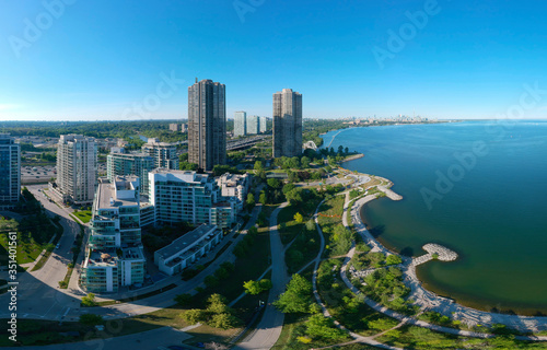 Artistic creative view of Humber Bay Shores Park city view and green space with skyline cityscape, azure lake Ontario. Skyscrapers over The Queensway on sunset at summer, Etobicoke, Ontario, Canada