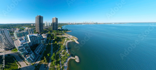 Artistic creative view of Humber Bay Shores Park city view and green space with skyline cityscape, azure lake Ontario. Skyscrapers over The Queensway on sunset at summer, Etobicoke, Ontario, Canada photo