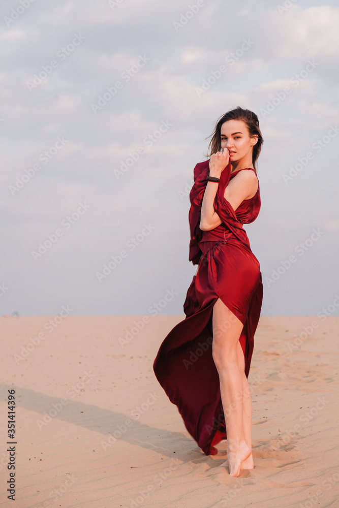 Girl in red dress at sunset in the desert Girl in red dress at sunset in the desert