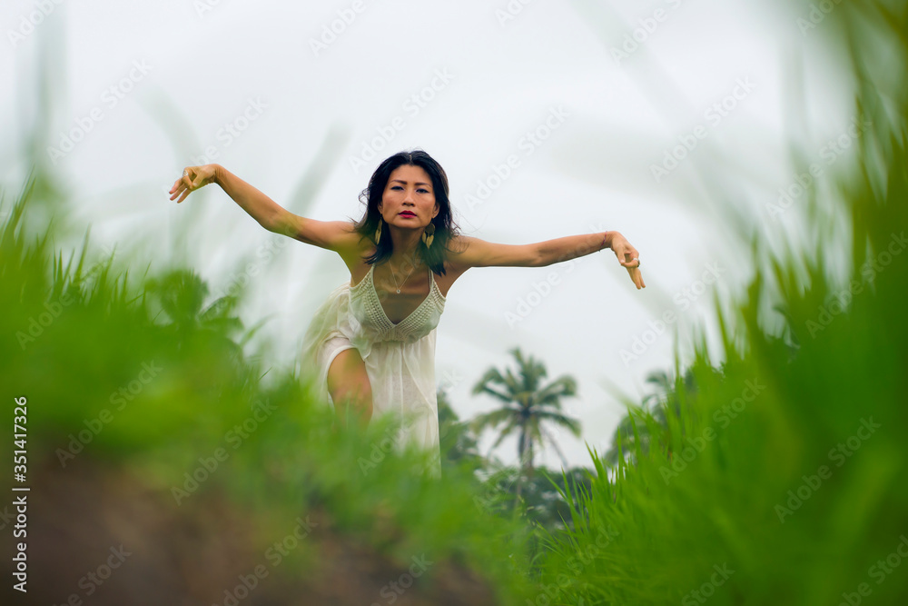 mind and body connection with nature - middle aged attractive and happy Asian Korean woman in Summer dress enjoying idyllic tropical destination dancing free mind and body connection with nature - middle aged attractive and happy Asian Korean woman in Summer dress enjoying idyllic tropical destination dancing free