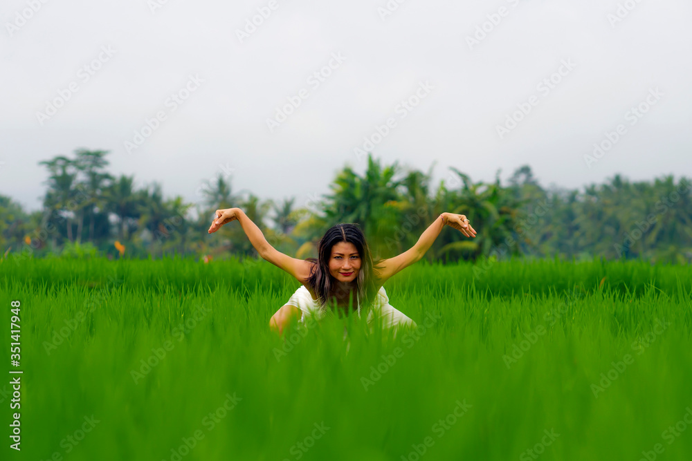 mind and body connection with nature - middle aged attractive and happy Asian Chinese woman in Summer dress enjoying idyllic tropical destination dancing free mind and body connection with nature - middle aged attractive and happy Asian Chinese woman in Summer dress enjoying idyllic tropical destination dancing free