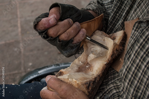 Tepatitlan de Morelos, Jalisco / Mexico - Jul 2010
Close up of hands carving a Religious figure in wood
Crafts-production employs are a significant percentage of the municipality's residents incomes photo