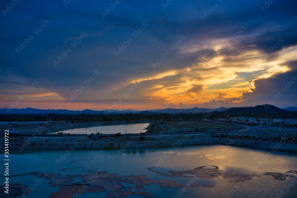Fototapeta premium This unique photo shows the hilly landscape with lakes, from hua to thailand, taken with a drone during a fantastic sunset!