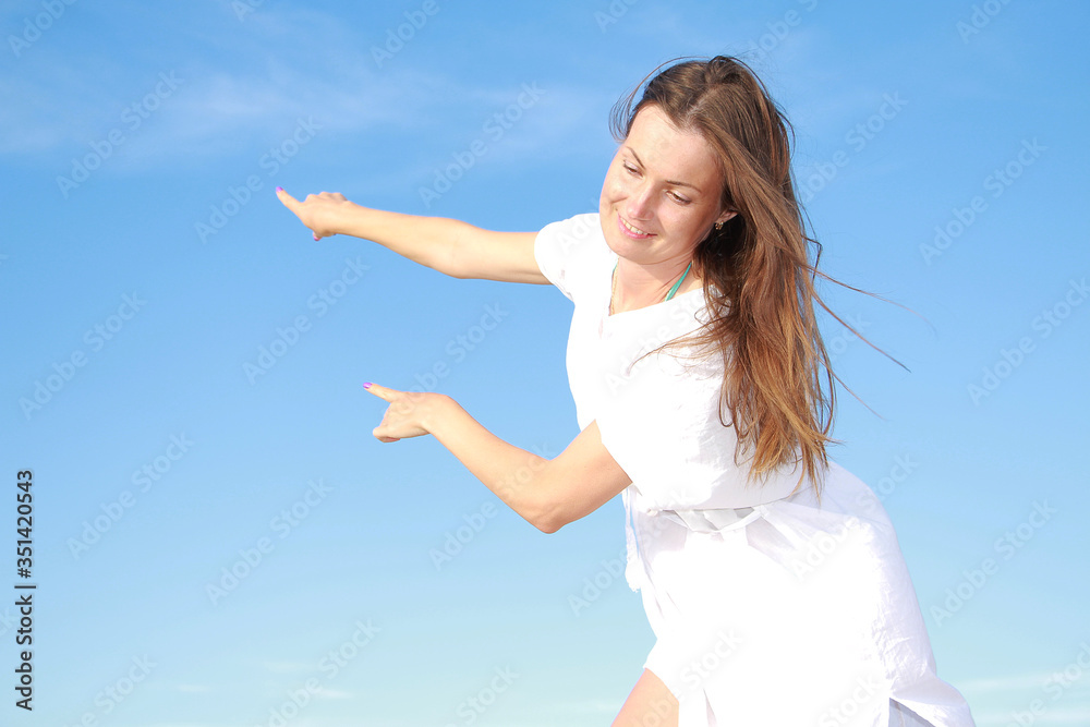 girl on a background of blue sky girl on a background of blue sky