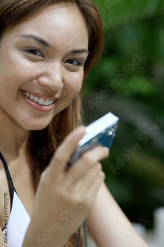 Slika na platnu Woman posing with digital camera