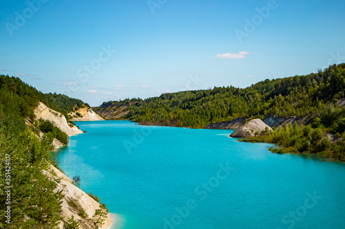Unusual lake with turquoise water in the crater. Rocky stony shore chalk quarry in Belarus. © Galina Atroshchenko