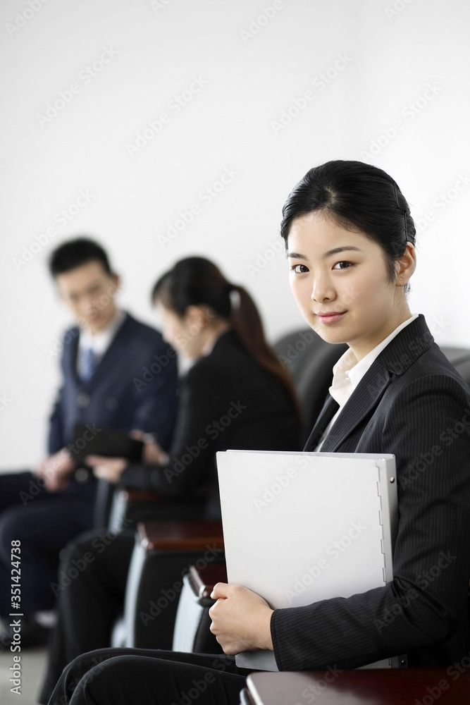 Businesswoman with document smiling at the camera Businesswoman with document smiling at the camera