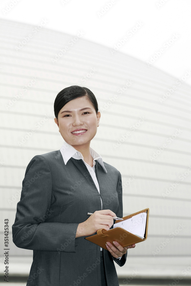 Businesswoman holding an appointment diary Businesswoman holding an appointment diary