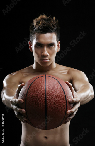 Man with basketball staring at the camera © ImageHit