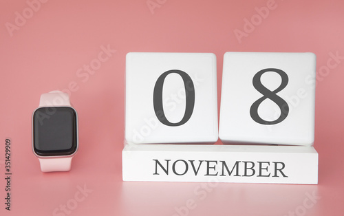 Modern Watch with cube calendar and date 08 november on pink background. Concept autumn time vacation.