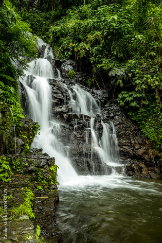 Waterfall landscape. Beautiful hidden Jembong waterfall in tropical rainforest in Ambengan  Bali. Slow shutter speed  motion photography.