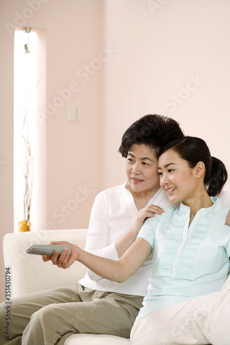 Two women watching television together