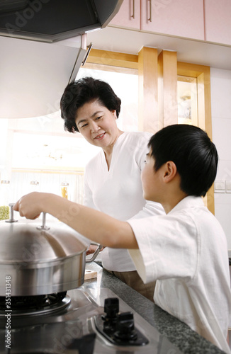 Mature woman and boy in the kitchen