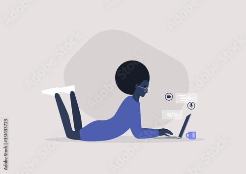 Young black female character lying on the floor and typing on a laptop, working from home concept