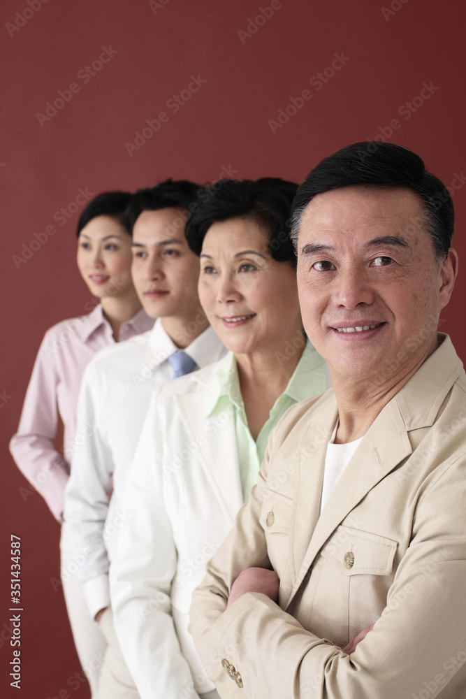 Men and women in business clothing standing in a row Men and women in business clothing standing in a row