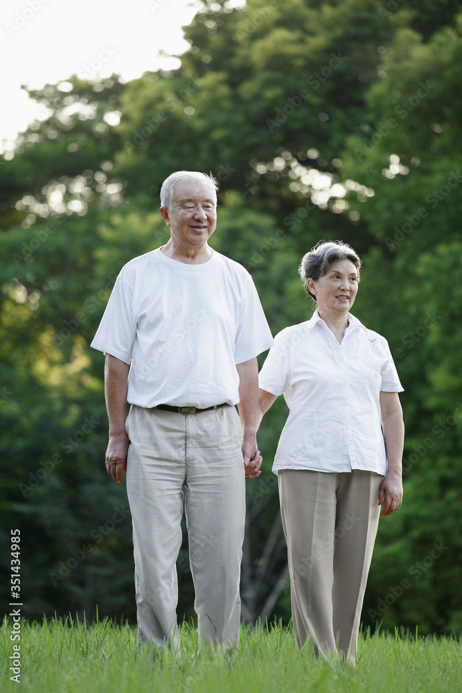 Senior man and senior woman holding hand while walking Senior man and senior woman holding hand while walking