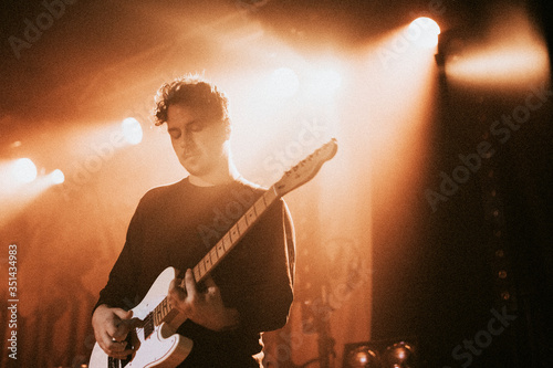Tablou pe pânză Guitarist playing an electric guitar in a concert